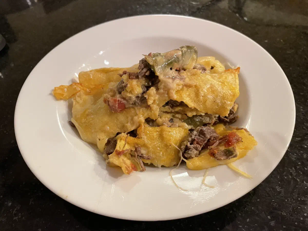 Messy plate of enchiladas